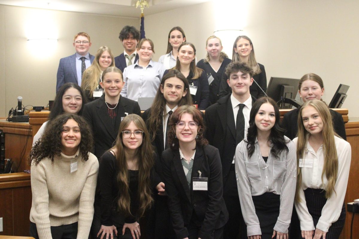 The WHS mock trial team poses in a courtroom before their first trial. WHS took second and fourth at the Northern Colorado Regional Mock Trial Competition.