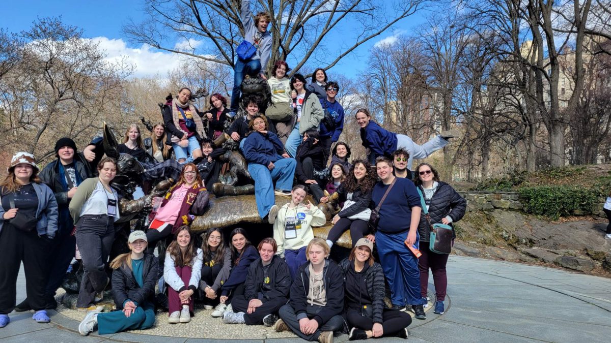 New York trip students and chaperones pose with a statue in Central Park. This took place on the final day of the New York trip. (Photo by Julie Estrada, used with permission)
