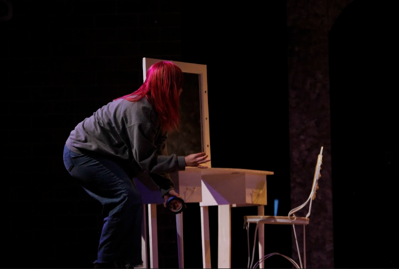 Assistant Director Shyre Johnson-Turner (12) spikes the stage in preparation for show night during night rehearsals. "I had to be quick due to the nature of the scene," Johnson-Turner said.