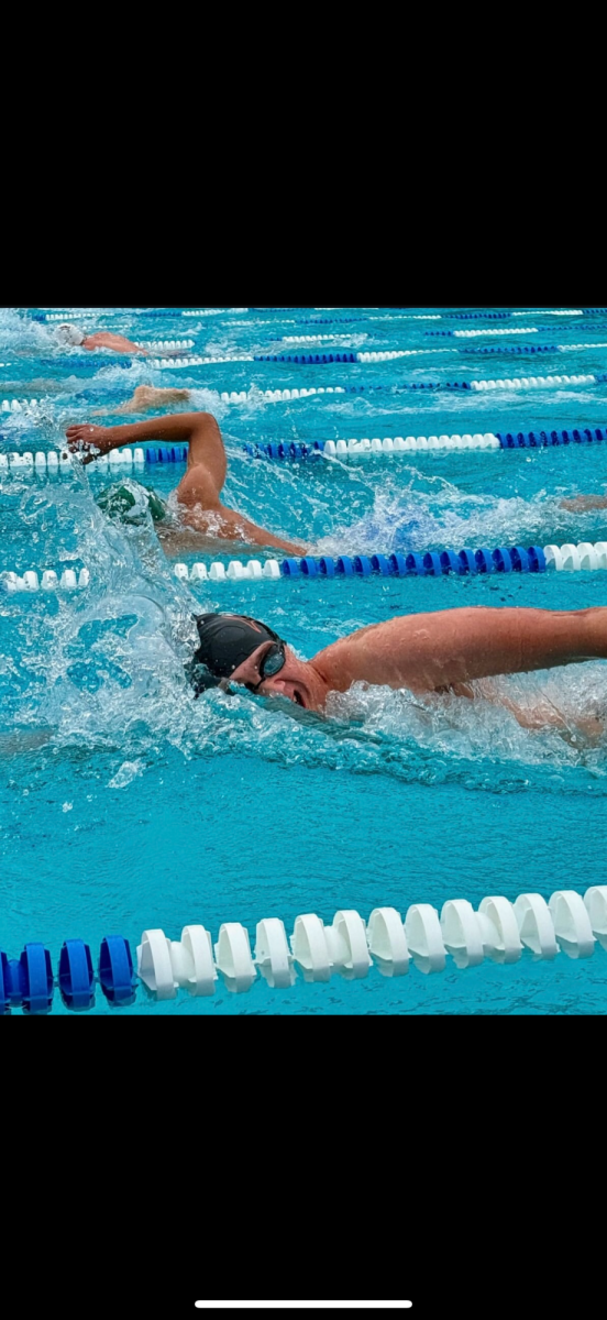 Kaden Sanger (12) swims in his final regular season race for WHS. As co-captain of the team, he pushed himself daily for the whole season. (Photo provided by Kaden Sanger)
