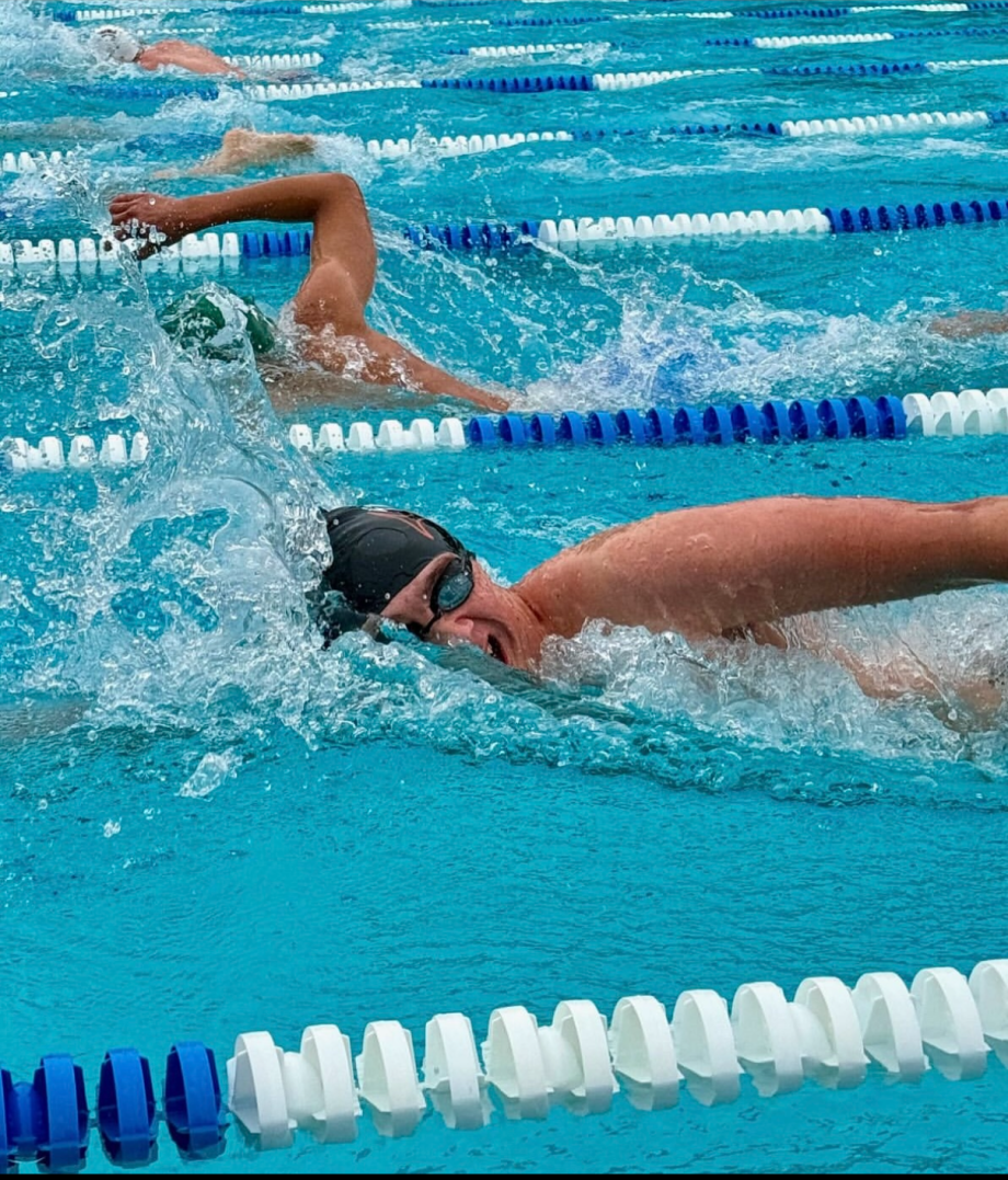 Kaden Sanger (12) swims in his final regular season race for WHS. As co-captain of the team, he pushed himself daily for the whole season. (Photo provided by Kaden Sanger)