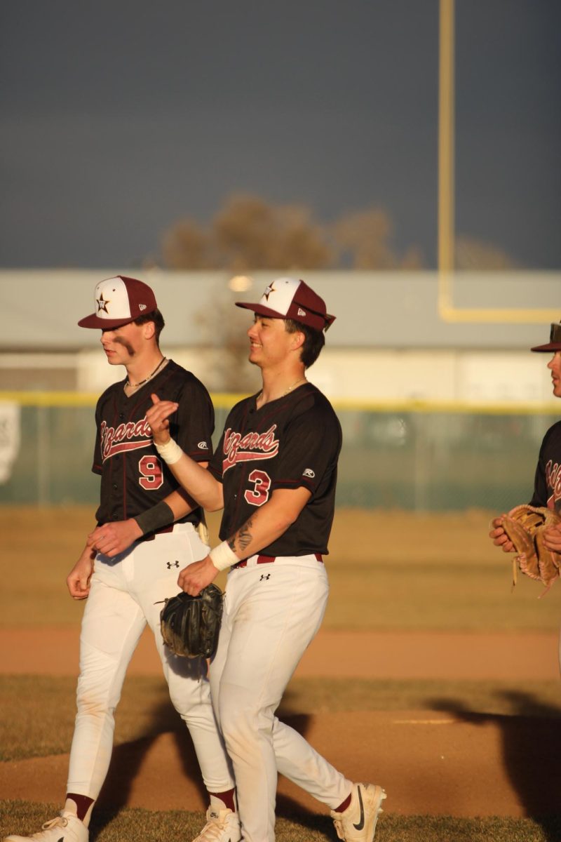 Ethan Fillinger (12) stands amongst his team after they won their game 13-8 against Severance on March 11. This was one of the games that helped bring them up to the start of the playoffs.