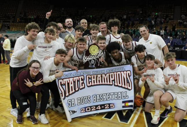 The Wizards celebrate after winning the state championship agianst Green Mountain 60-49 on March 16. This was coach Jonathan Rakiecki's (staff) first title as head coach. 